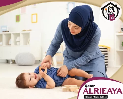 Babysitter Qatar 051898847 alrieaya Babysitter in Qatar helping a baby play safely at home.