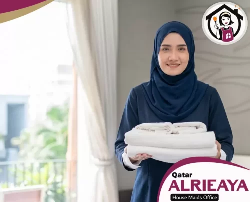 Indonesian Maid Service in Qatar 051898847 Alrieaya Indonesian maid holding fresh towels in a bright Qatar home.